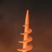 Close-up of a Sand Dog Screw in Peg, an orange plastic tent peg with a spiral design, used for securing tents or outdoor equipment in the ground. The background is out of focus.