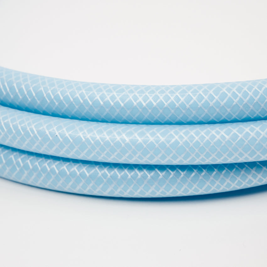 Close-up of the 1 x 5 meter extension hose inc fittings, light blue with a white crisscross pattern, coiled on a white background—ideal for Adventure Pumps or connecting to water tanks.