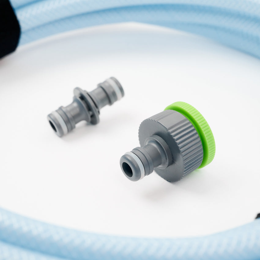 Close-up of the 1 x 5 meter extension hose inc fittings, featuring two gray connectors (one with a green ring) attached to a blue braided hose, designed for efficient water transfer and shown on a white surface.