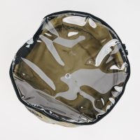 Top view of the open, round Adventure Pumps Canvas Bag in khaki with a transparent plastic lid. Hand made and empty, it sits against a plain white background—ideal for carrying your Adventure Pumps.