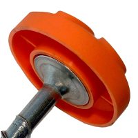Close-up of a Ground Puppy® Cap from the 4 Pack, orange plastic wheel attached to a metal rod or support bracket, viewed at an angle.