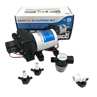 A Seaflo 12V RV Supreme Pump set, featuring a quiet self-priming pump in black and white with connectors, filter, and accessories, is displayed in front of its branded packaging box.