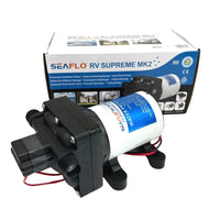 A Seaflo 12V RV Supreme Pump is displayed in front of its box, showing the product label and wiring. The packaging highlights features and includes a picture of this quiet RV water pump.